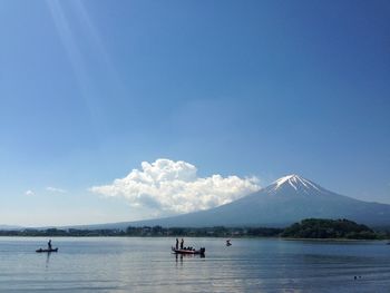 Scenic view of lake by mountain against sky