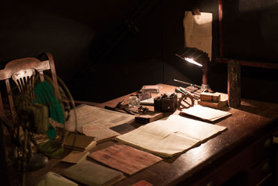 Illuminated lamp on table at night