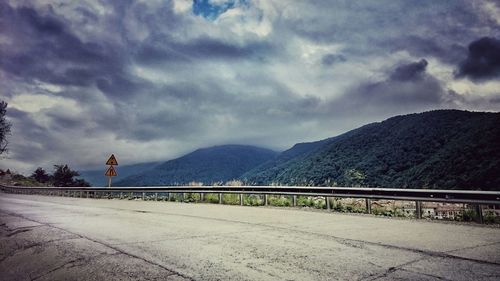 Scenic view of mountains against cloudy sky