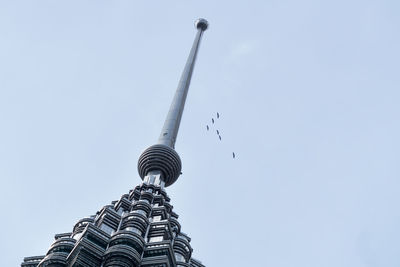 Low angle view of communications tower against clear sky