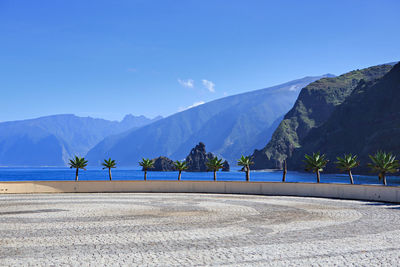 Scenic view of mountains against blue sky