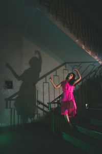 Beautiful young woman standing on steps