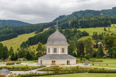 Scenic view of trees and buildings against sky