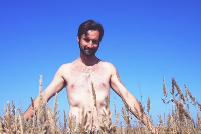 Low angle view of man against clear blue sky