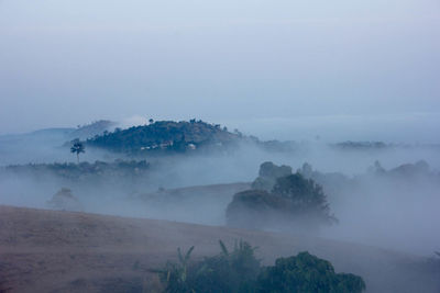 Scenic view of mountains against cloudy sky