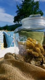 Close-up of glass jar on table at beach