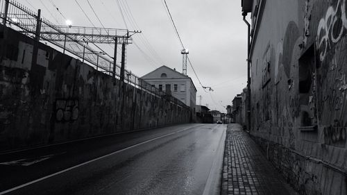Bridge amidst buildings against sky