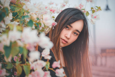 Portrait of woman with pink flowers