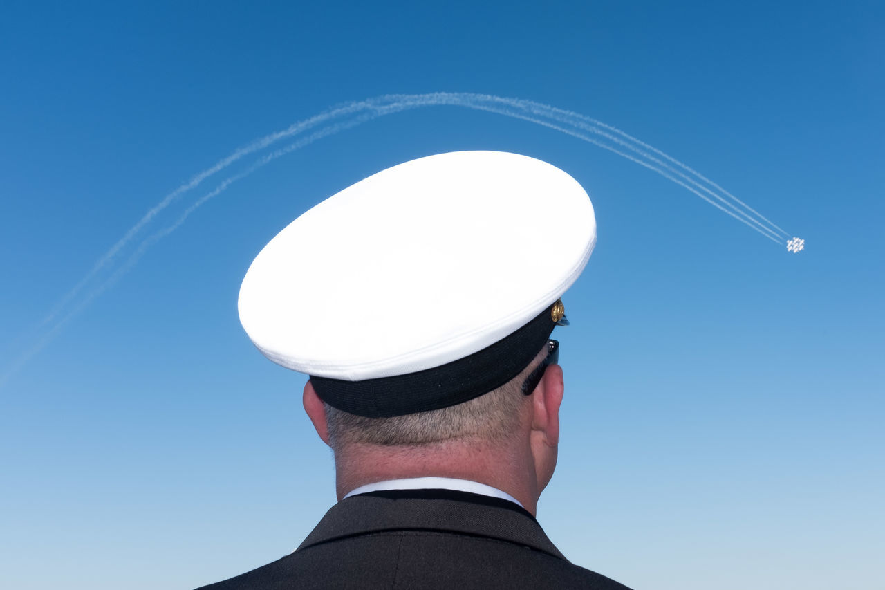 men, rear view, clear sky, low angle view, real people, one person, blue, day, headshot, military uniform, outdoors, occupation, sky, military, people