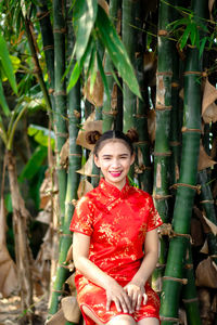 Portrait of smiling young woman standing outdoors