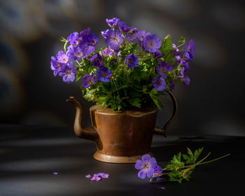 Close-up of purple flower pot on table