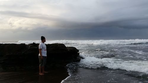 Rear view of woman standing on beach