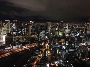 High angle view of illuminated cityscape against sky at night