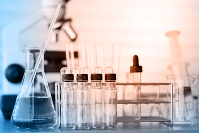 Close-up of beaker with test tubes on table at laboratory