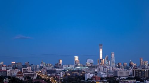 Modern buildings against clear blue sky