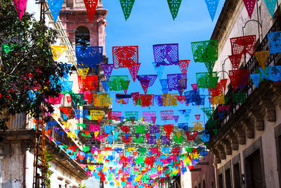 Low angle view of multi colored buildings hanging in city