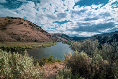 Scenic view of lake and mountains against sky