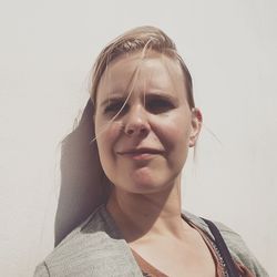 Close-up portrait of young woman against white background