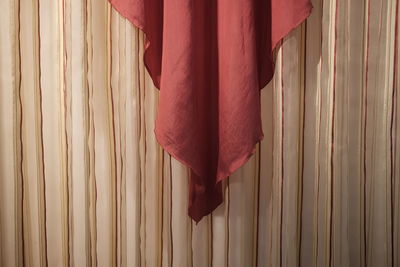 Close-up of red fabric hanging on wall