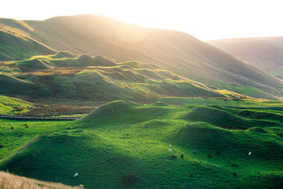 Scenic view of hills and mountains during sunset