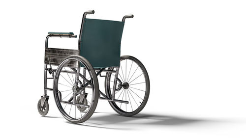 Close-up of wheelchair against white background