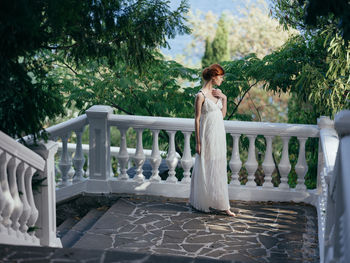 Woman standing by railing