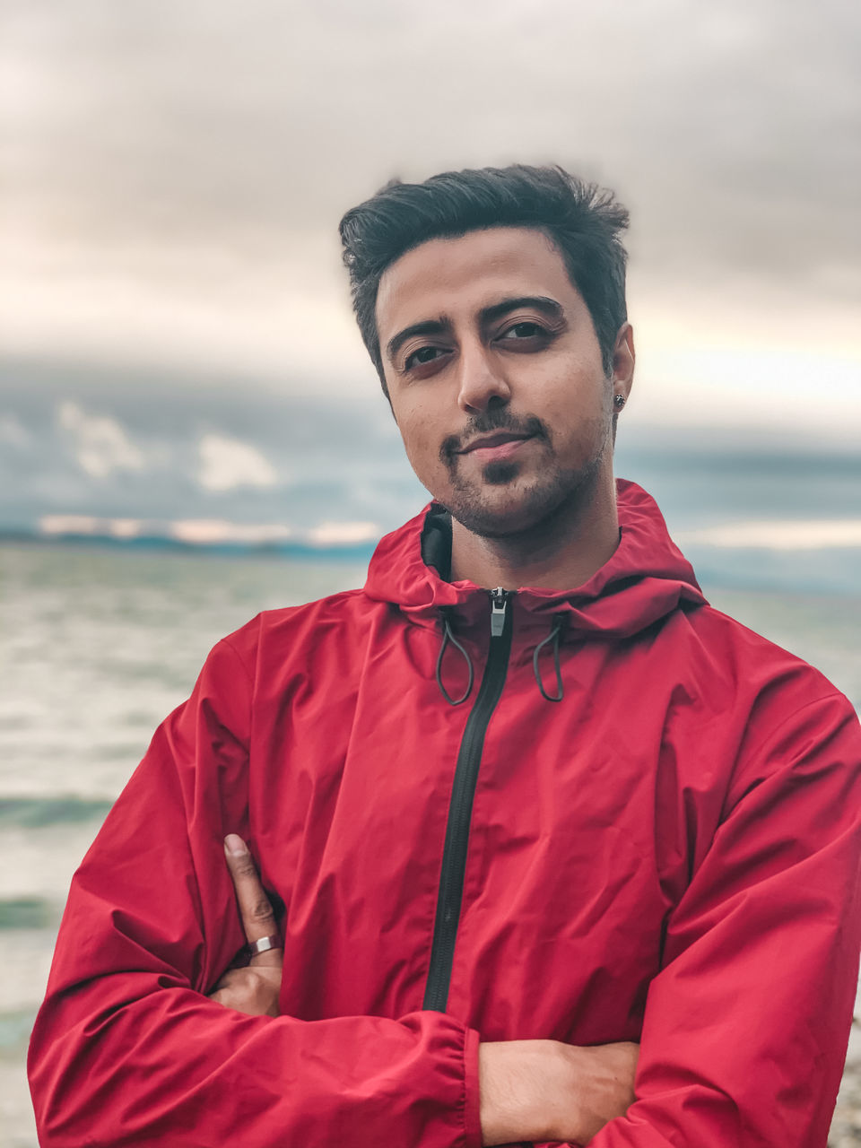 PORTRAIT OF YOUNG MAN STANDING IN SEA