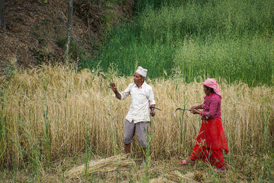 Full length of a man standing in field