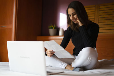 Woman doing her resume on the computer.