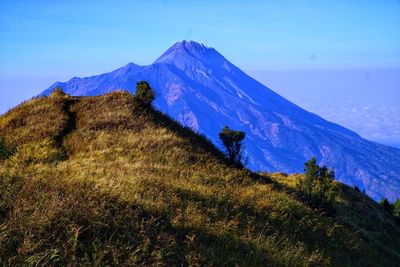 Scenic view of mountains against clear blue sky