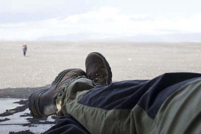 Low section of man against sky