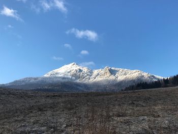 Scenic view of mountains against blue sky