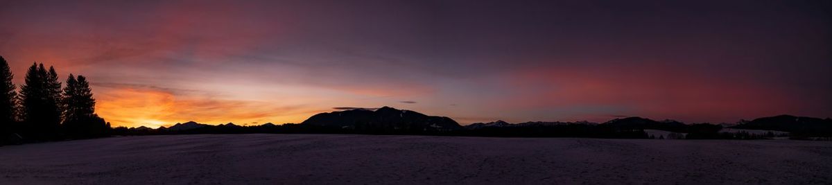 Scenic view of silhouette land against sky during sunset