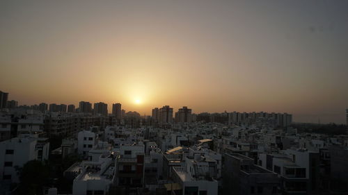 Cityscape against sky during sunset