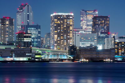 Illuminated buildings against sky at night