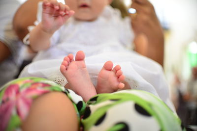 Midsection of mother and baby hands