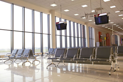 Empty chairs at airport lounge