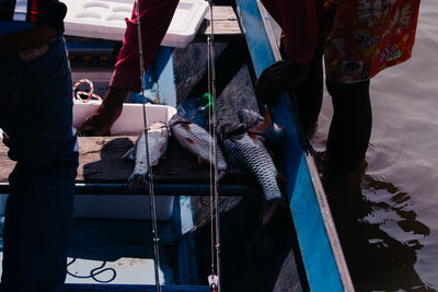 Low section of people working in boat