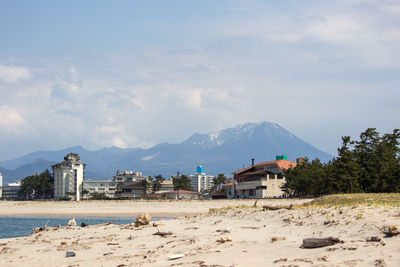 Panoramic view of beach and buildings against sky