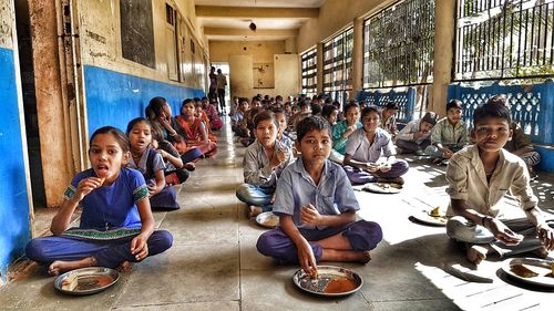 Children sitting in corridor