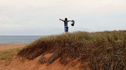 Full length of woman standing on beach