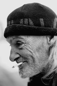 Close-up of man wearing hat looking away