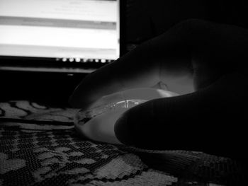 Close-up of man hand on bed