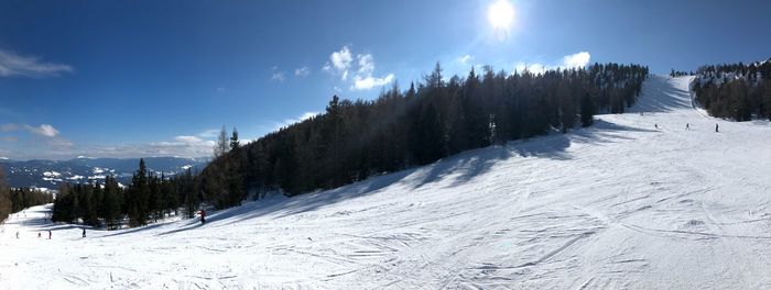 Panoramic view of snow covered landscape against sky