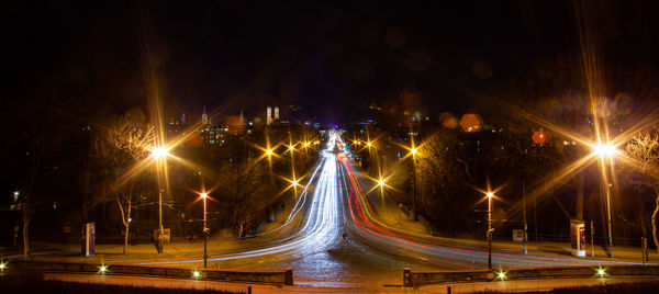 Illuminated light trails on road at night