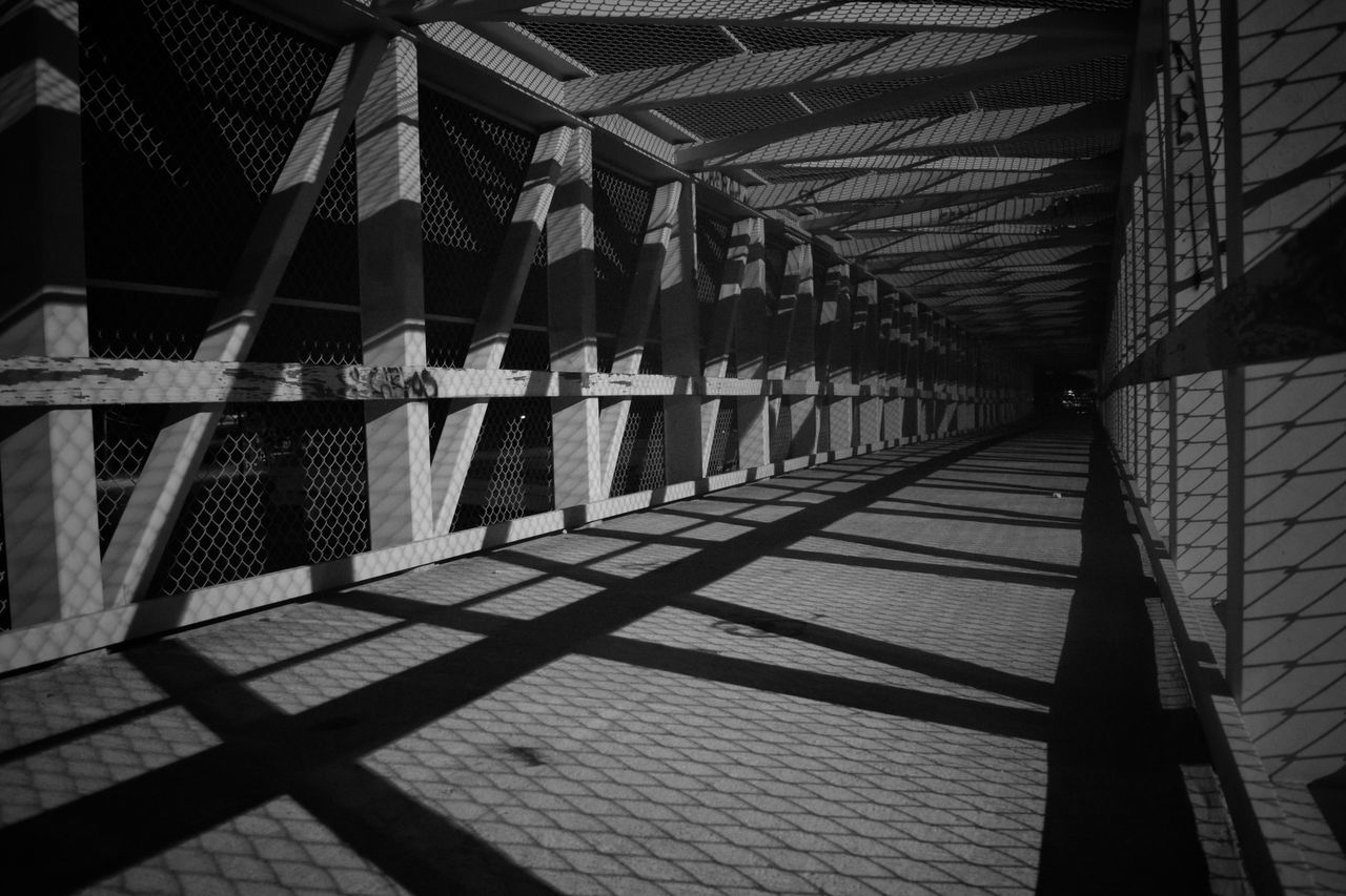 built structure, architecture, shadow, the way forward, pattern, building exterior, sunlight, diminishing perspective, in a row, indoors, empty, railing, day, design, building, no people, metal, low angle view, walkway