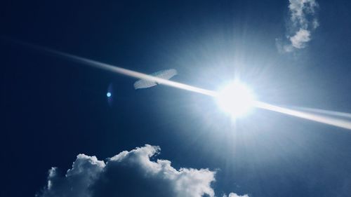 Low angle view of vapor trail against blue sky