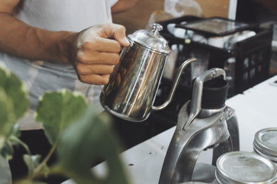 Midsection of man preparing coffee