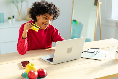 Young woman using laptop at table