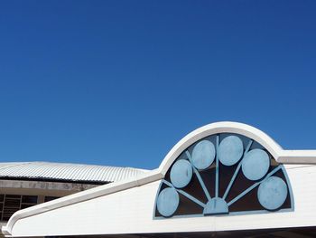 Low angle view of house against clear blue sky